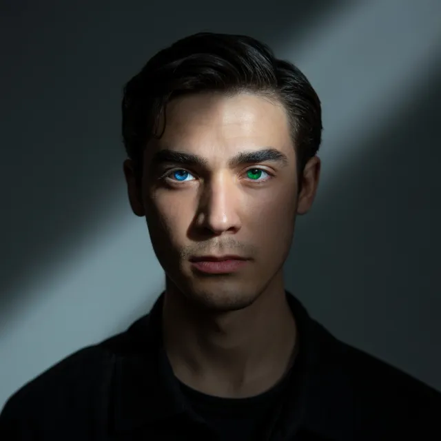 A studio headshot of a young man with one blue eye and one green eye (heterochromia) - Ideogram 3.0 (Quality)