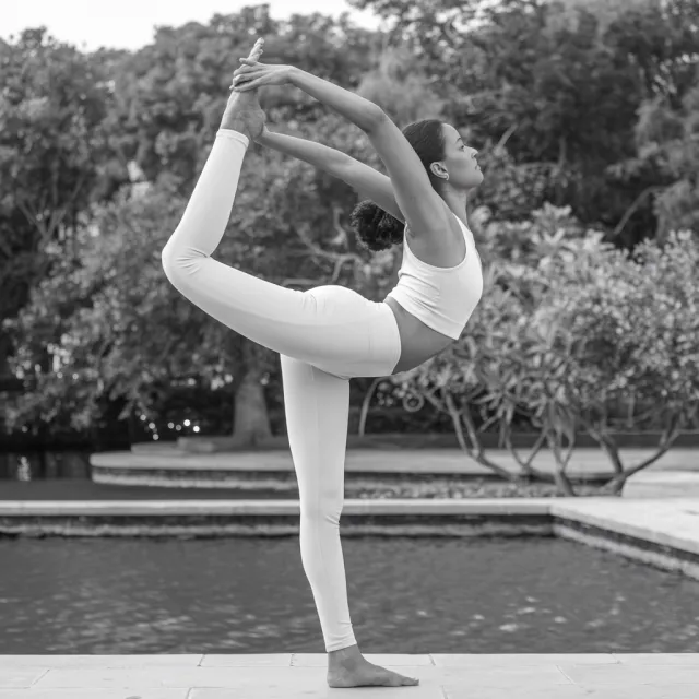 A yoga practitioner in a complex pose, arms and legs fully extended (full-body view) - Ideogram V2