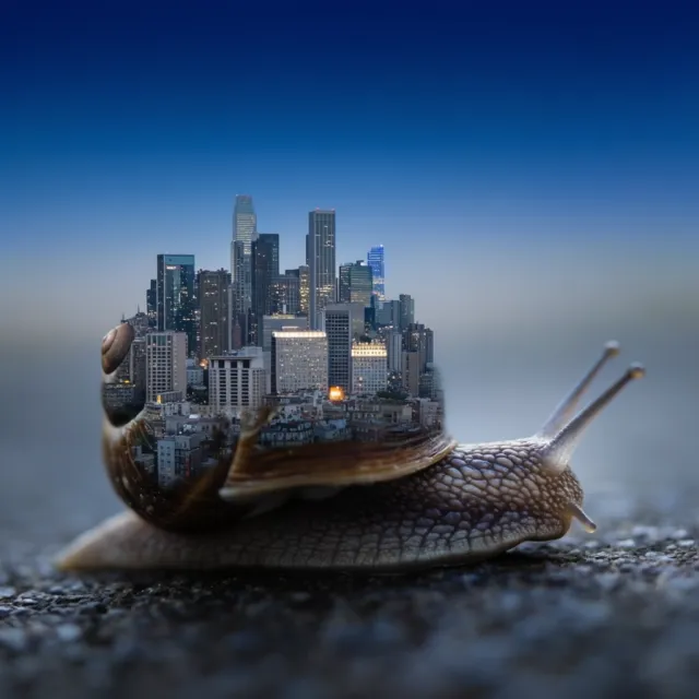 A snail whose shell contains a miniature city skyline, depicted in a hyperrealistic macro… - Krea 2 Large