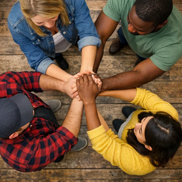 A group of five people joining hands in a circle, seen from above. - GPT Image 1.5