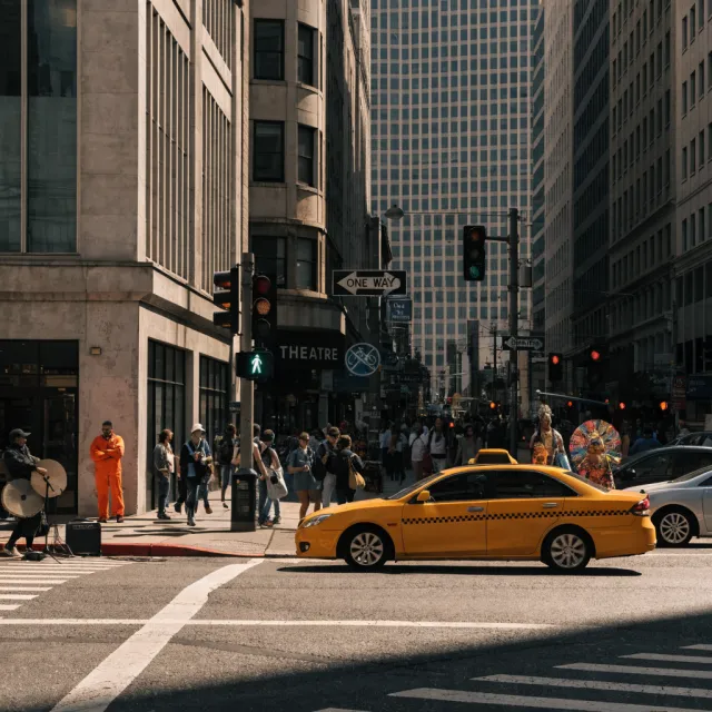 A busy city intersection with cars, pedestrians, and street performers all in one frame - Recraft V4.1